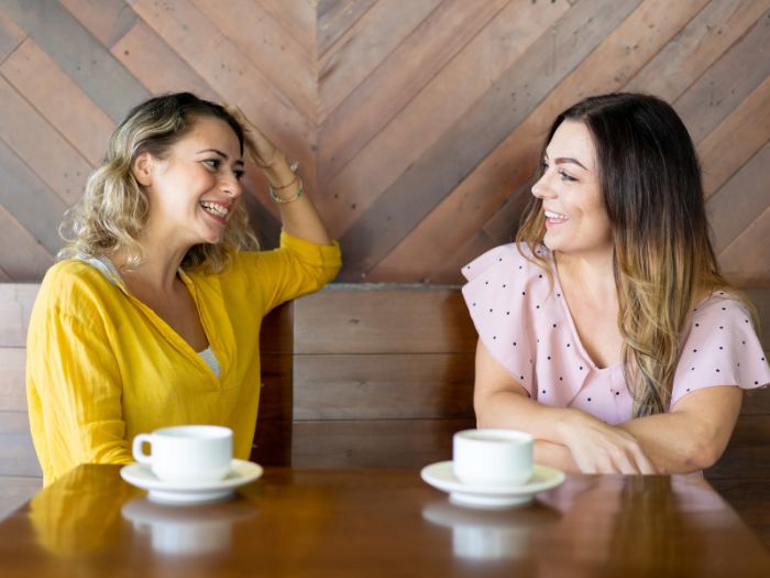 Two healthy women enjoy coffee