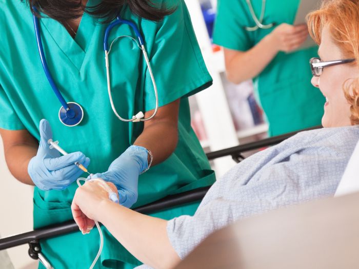 A nurse administering Iron infusions